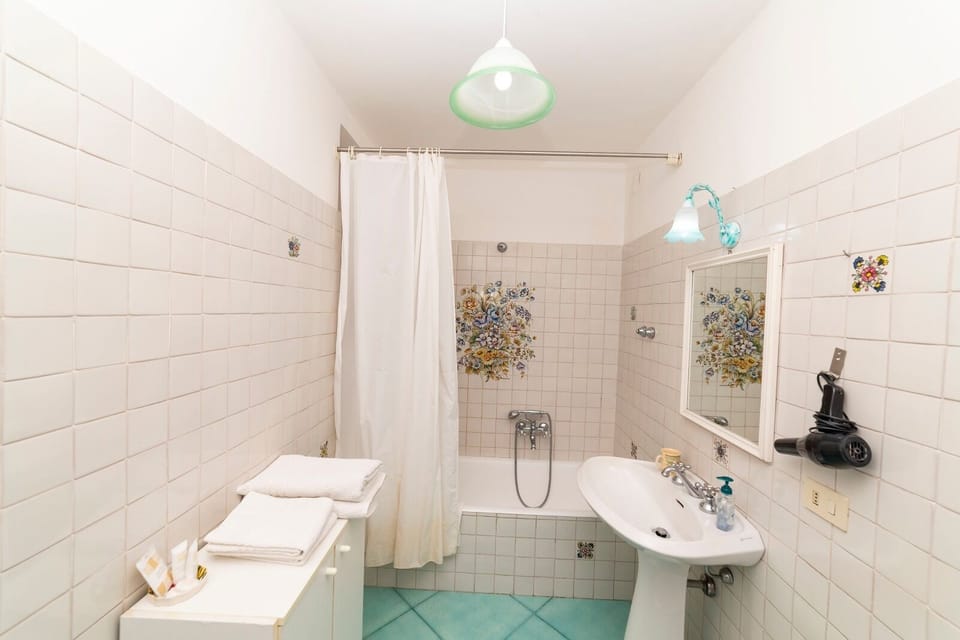 Family Quadruple Room, 2 Double Beds | Bathroom | Hair dryer, bidet, towels
