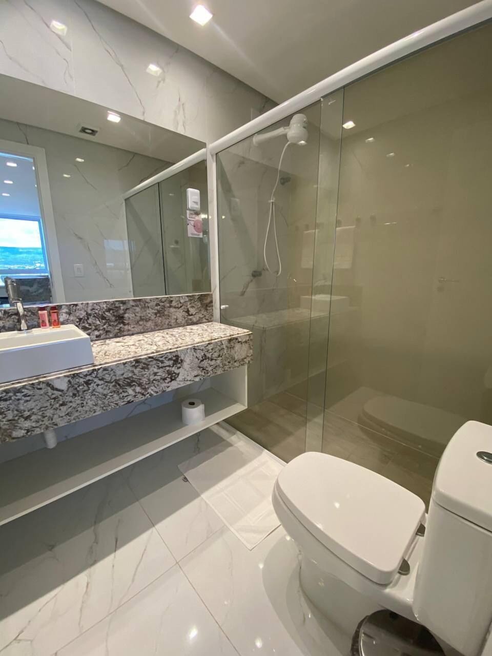 Shower, towels, shampoo, toilet paper