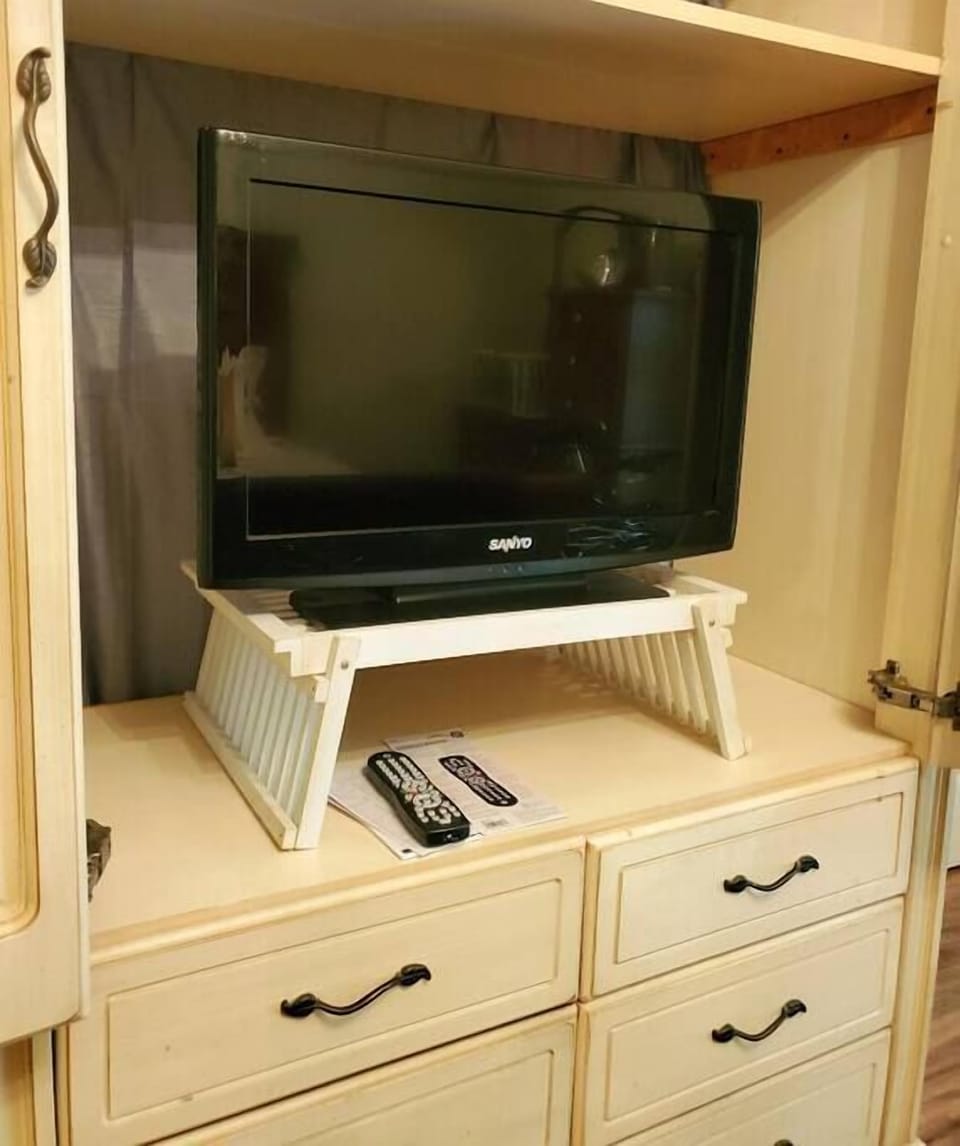 Flat screen TV in master bedroom. 