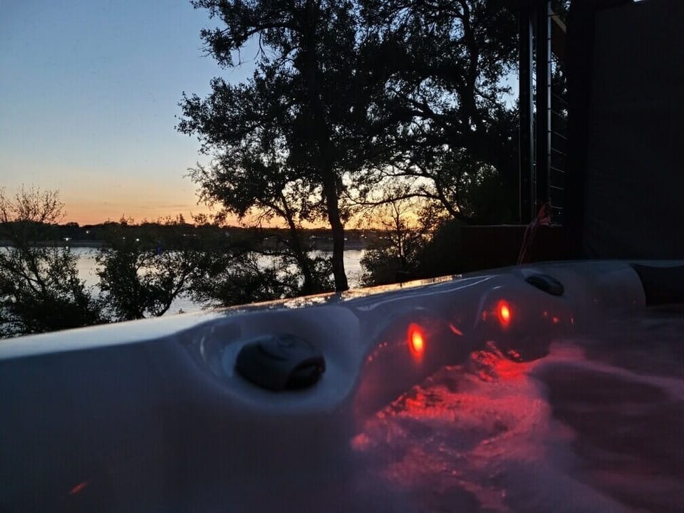 Relax in a cozy hot tub on a spacious lakefront deck. Enjoy bubbling water, fresh air, and peaceful views—perfect for unwinding and spending time with friends or family.