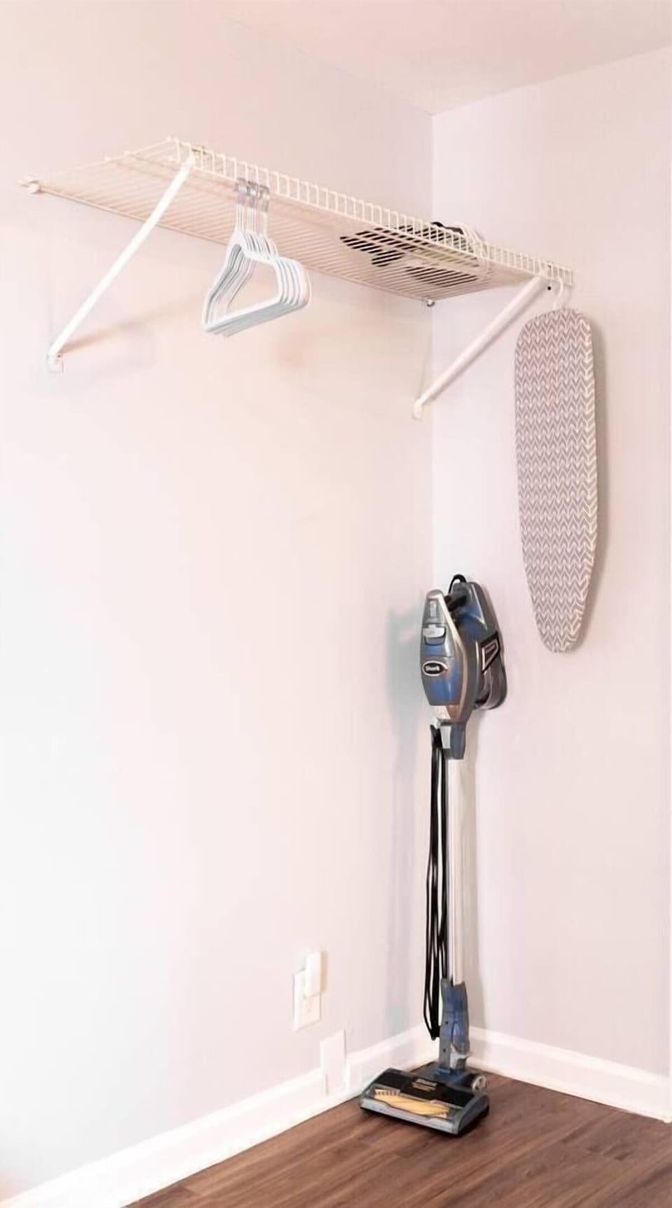 Hangers, iron, countertop sized ironing board, Pac 'n' Play, portable fan & vacuum stored in the master bedroom