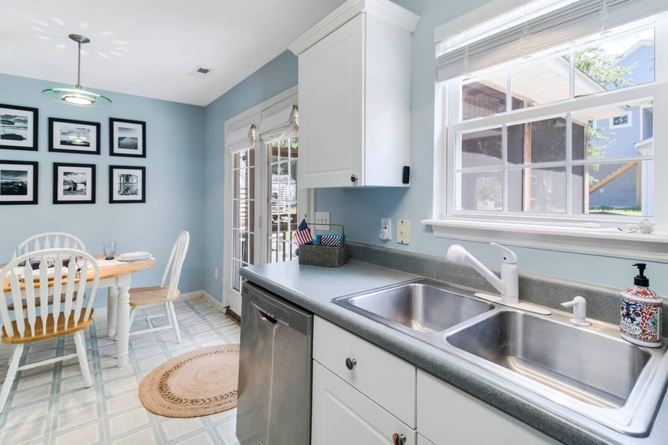 The Open Concept Kitchen & Dining Room makes for Easy Serving & Cleanup. Lots of Natural Light from the Doors to the Porch.