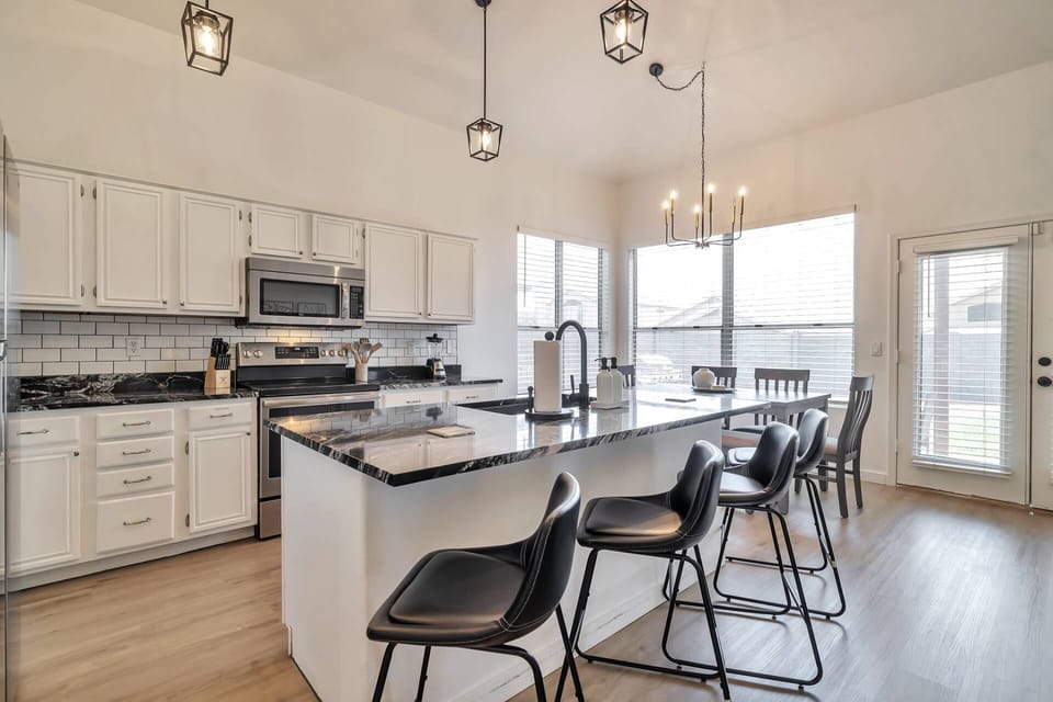 Kitchen features a Keurig coffee maker, cook top stove, dishwasher, refrigerator