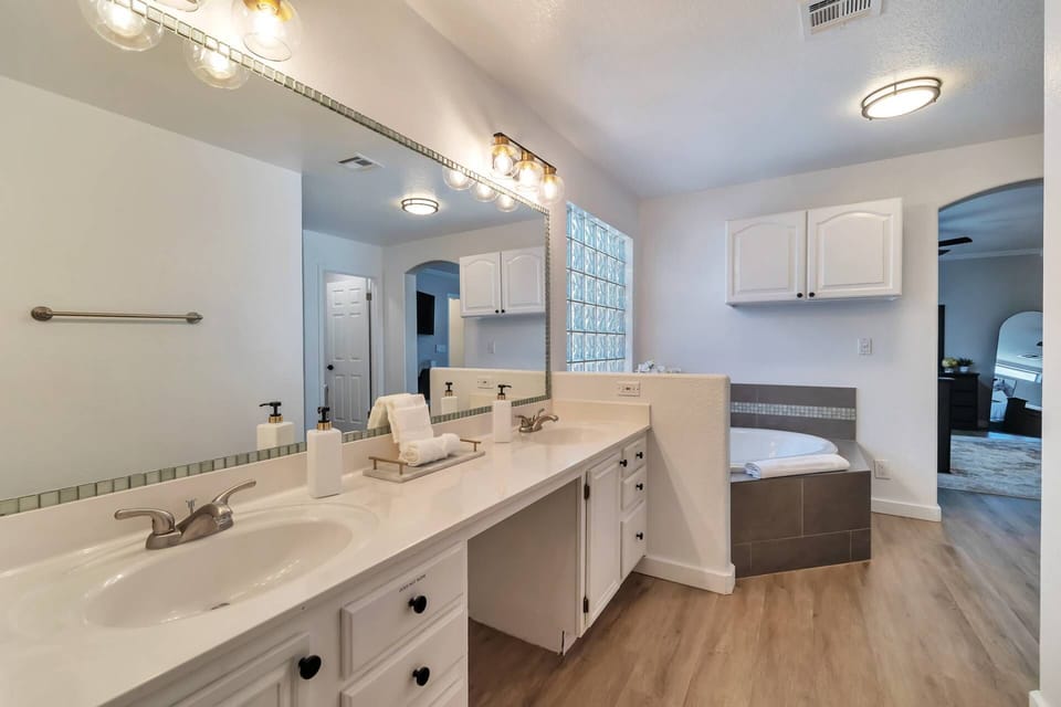 Master bathroom features double sinks, garden tub (jets not operable), walk in shower & closet