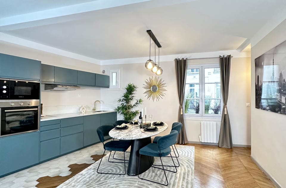 A long dining table with a view of the kitchen and the lounge area