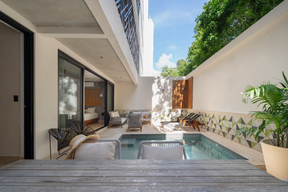Private patio with plunge pool and outdoor dining for relaxation and sun.