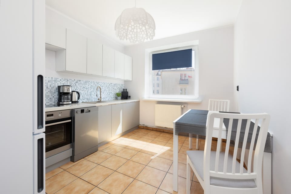 Well-lit kitchen and dining space featuring a cozy and functional layout.


