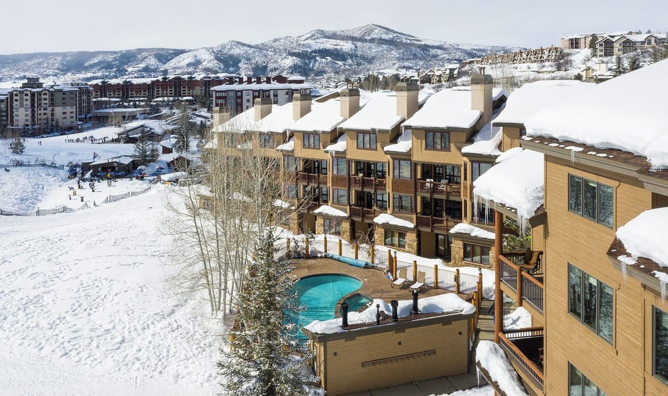 Your fully equipped kitchen features granite countertops, stainless steel appliances, and a spacious island with seating—perfect for preparing meals and gathering together during your mountain getaway.