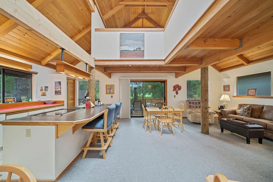 Open living space with fully equipped kitchen with breakfast bar, dining table, Pellet stove.