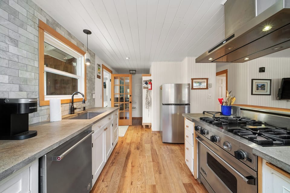 Fully equipped kitchen with Viking stove, Dishwasher, Microwave, Kuerig coffee maker, open to the living and dining area.