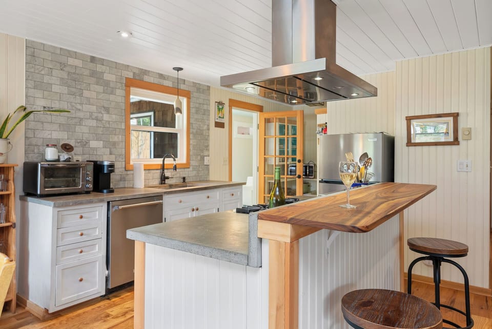 Fully equipped kitchen with Viking stove, Dishwasher, Microwave, Kuerig coffee maker, open to the living and dining area.