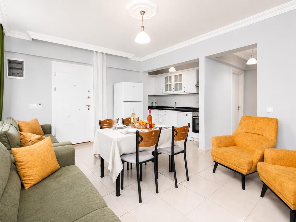 Living room with sofa, dining area, kitchen, A/C, WiFi internet, and satellite TV