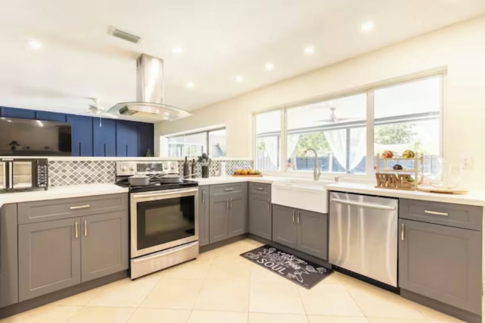Open kitchen with coffee machine toaster microwave oven.