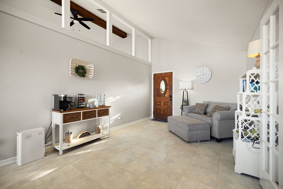Airy vaulted living room with coffee bar, clerestory light, cozy sectional