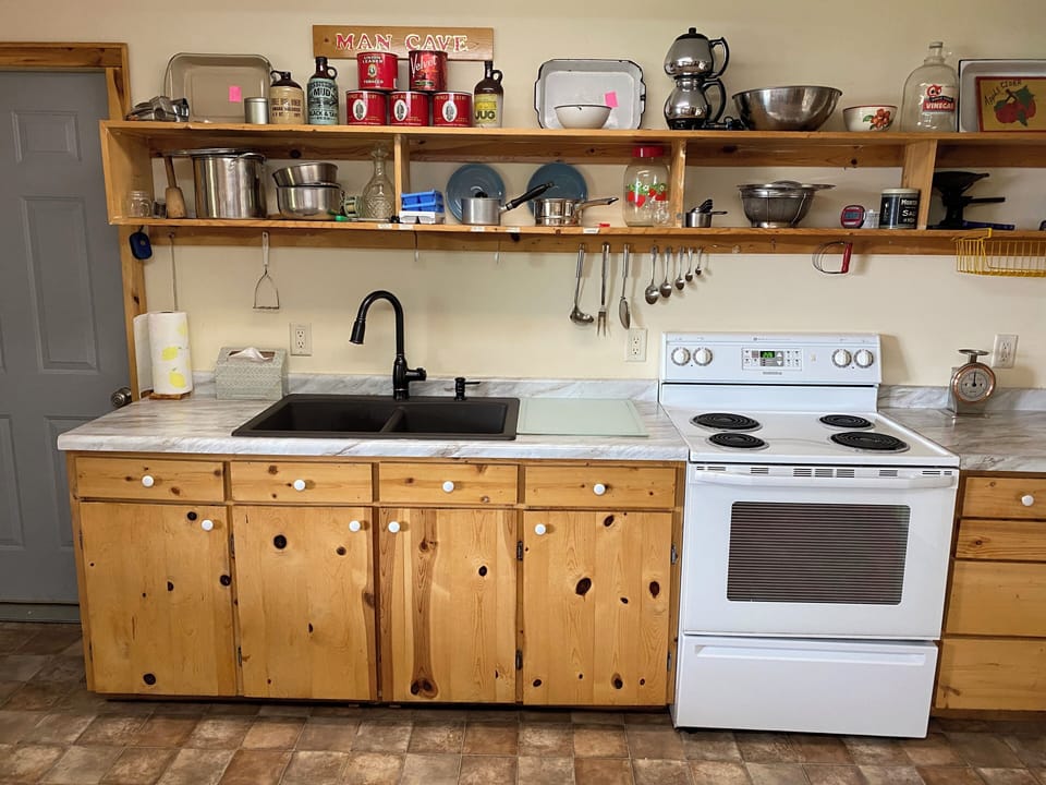 Basement kitchen with extra full size frig, stove, and area to clean fish.