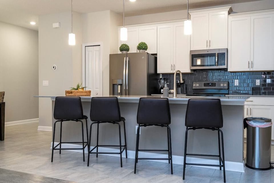 The fully equipped kitchen features modern appliances, sleek cabinetry, and all essential cookware and utensils, making it perfect for preparing meals with ease.