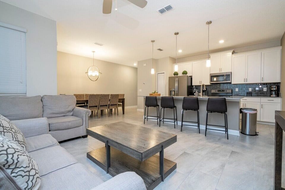 Step into this spacious, comfortable living area. The expansive room is adorned with tasteful decor, offering a blend of modern aesthetics and homey warmth. 