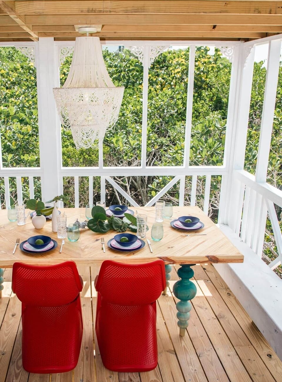 Lovely dining table on the screened porch aligns with a pass thru window from the kitchen