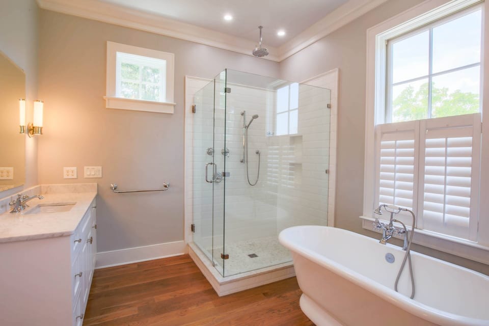 The lower primary en suite bathroom features a soaking tub, double vanities and tiled, walk-in shower.