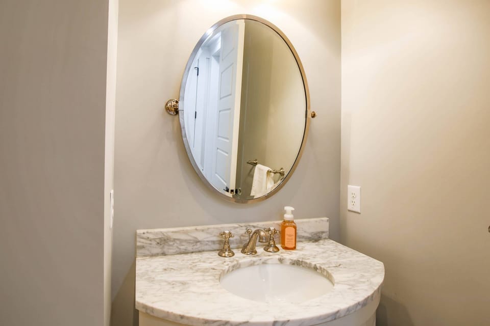 You'll find this half bathroom in between the kitchen and lower primary suite.