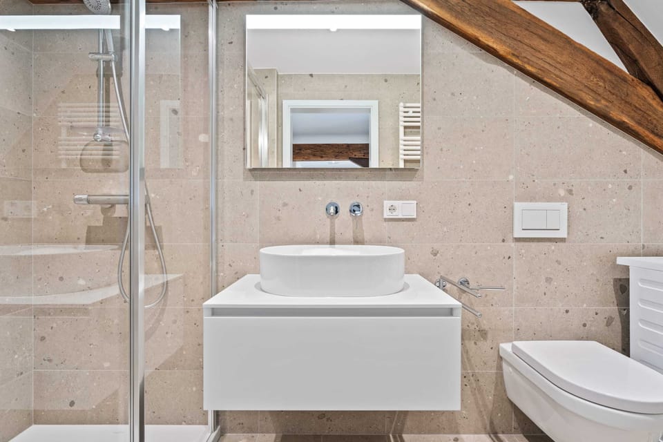 Refresh in our modern bathroom, complete with a sleek vanity, spacious shower, and elegant finishes for a luxurious experience.