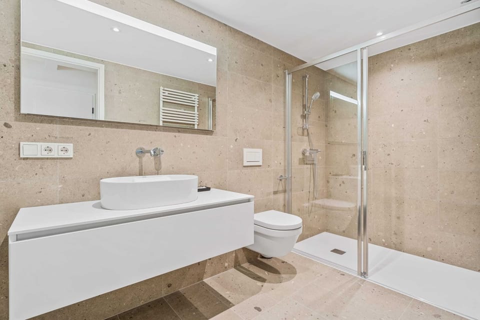 Chic bathroom aesthetics with spacious walk-in shower for a refreshing start to your day.