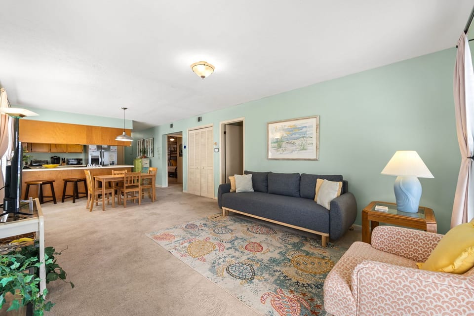 Open living and dining area with a modern kitchen and comfortable seating.