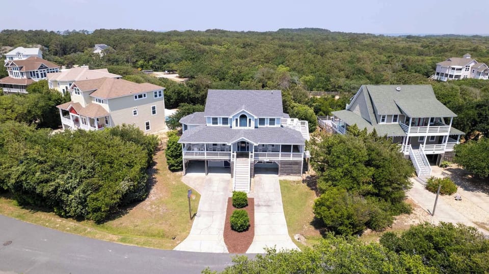 Drone - Double driveways for parking and a warm bright exterior to meet you and your guests.