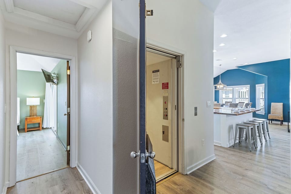 Hall Way - From the kitchen just past the elevator, you'll reach the top floor primary.