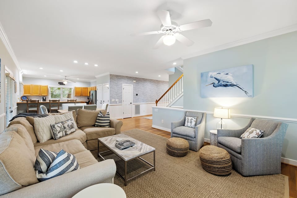 Lots of comfortable seating for your entire group in this bright and open living room.