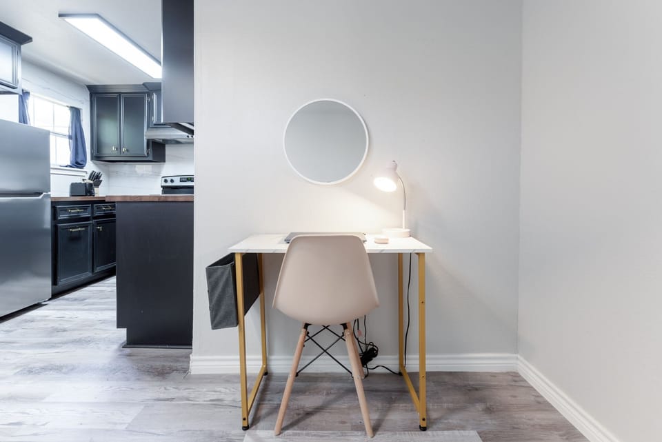 Boost your productivity in our well-equipped workspace, featuring a dedicated table and a convenient lamp for focused efficiency and creativity.