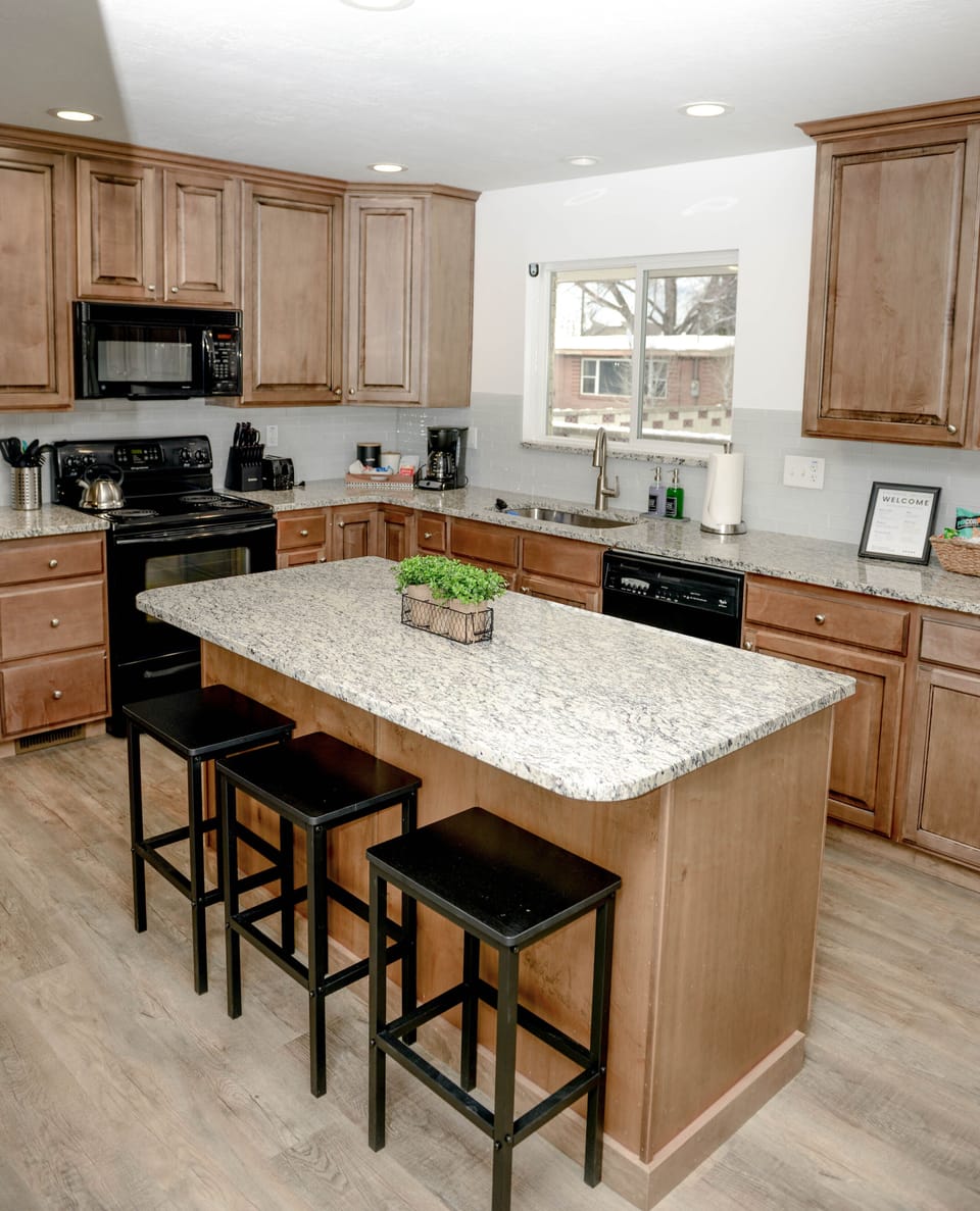 The upstairs kitchen has an open flow and a large island with extra seating
