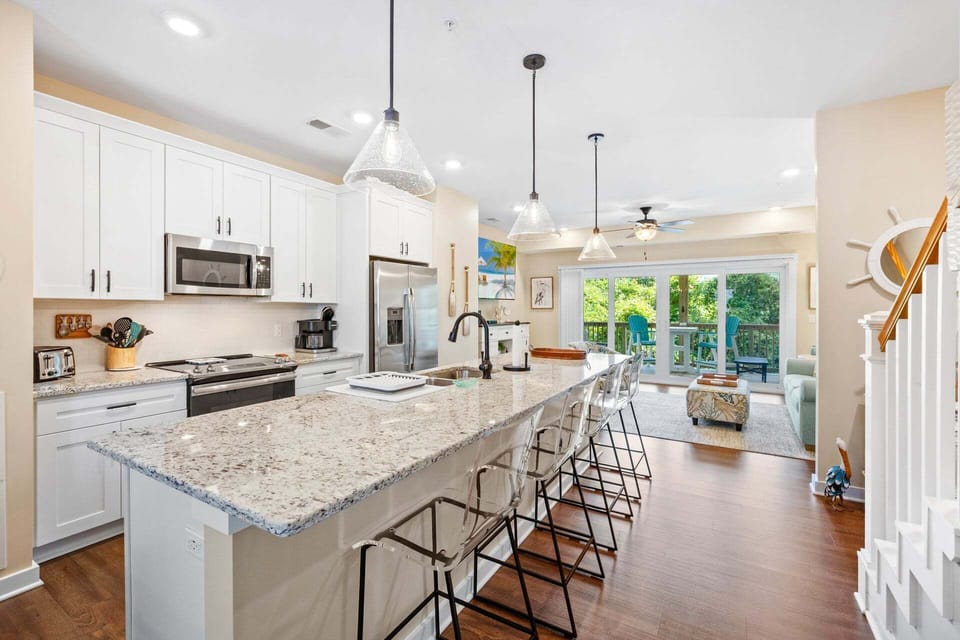 The open-concept Kitchen with Stainless Steel Appliances is ideal for whipping up a delicious meal to enjoy together as a family.