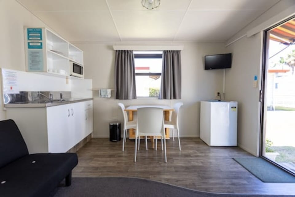 Kitchen Cabin (No Linen Supplied) | Living area | 22-inch flat-screen TV with digital channels, TV, books