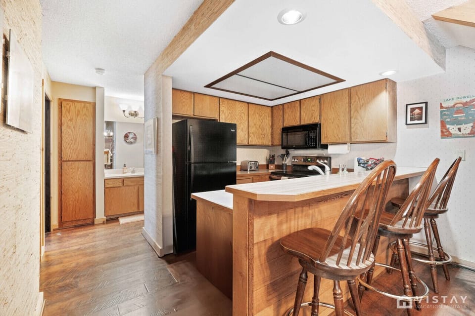 Kitchen bar area with 3 additional stools, providing extra seating for meals or casual gatherings.