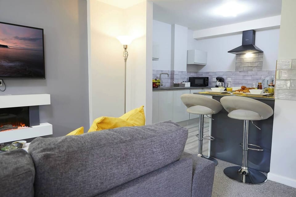 A Seamless Blend of Comfort and Functionality: The Perfect Harmony of Living, Dining, and Kitchen Spaces TV.