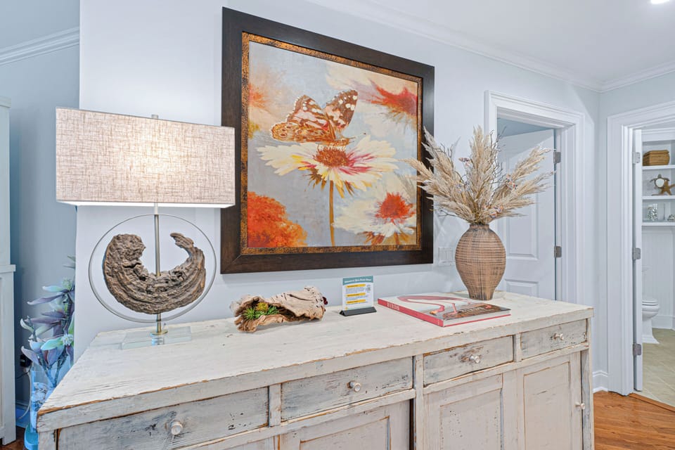 Thoughtfully styled with coastal-inspired décor—featuring curated artwork, warm textures, and inviting accents that bring a relaxed Lowcountry feel throughout the space.