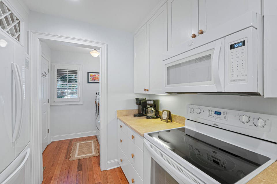 Well-appointed kitchen with full-size appliances and coffee station, with a convenient laundry area just steps away for added ease during your stay.
