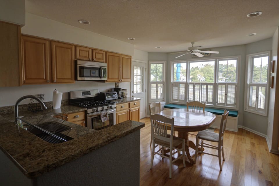 Kitchen comes fully stocked with essentials and breakfast table.
