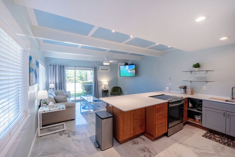 Large open plan living room/kitchen with ocean views
