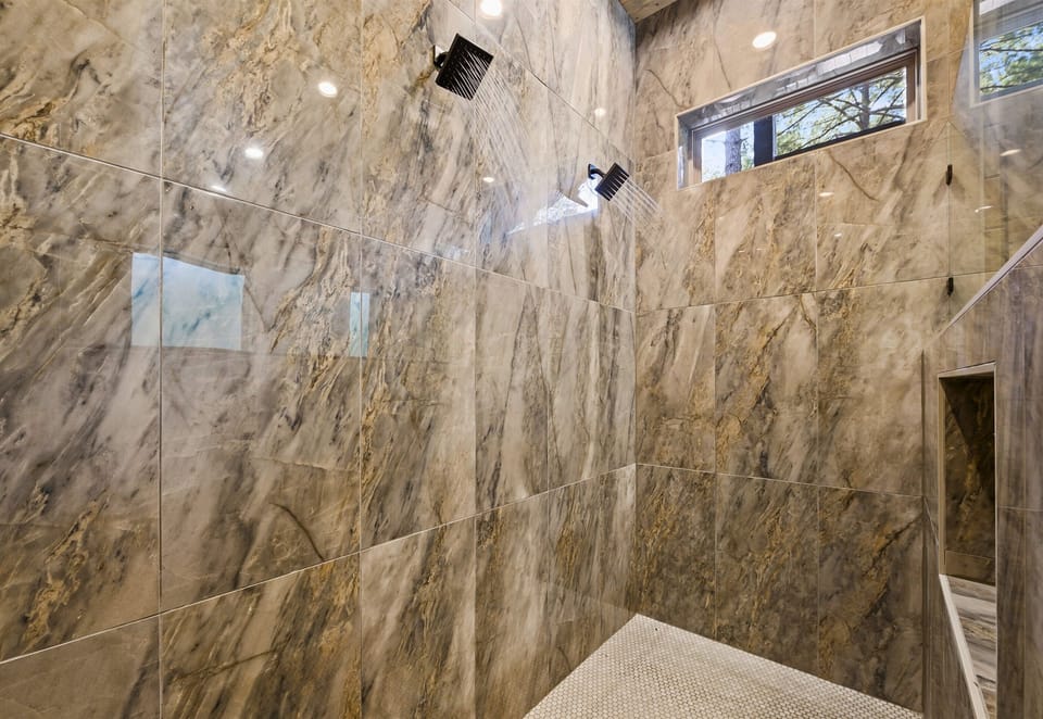 Experience the luxury of this large, beautifully tiled shower.