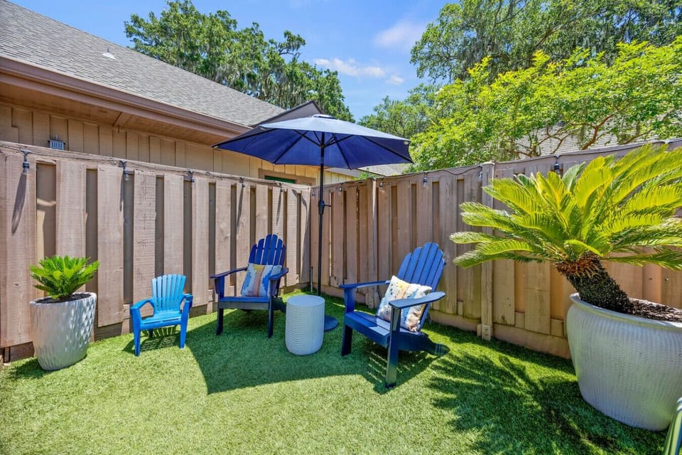 Private outdoor patio with seating and umbrella. Perfect for relaxing outside.