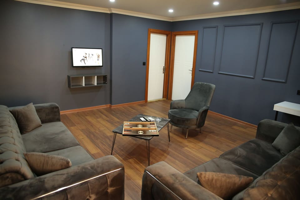 Basic Apartment | Living area | 82-inch LCD TV with satellite channels