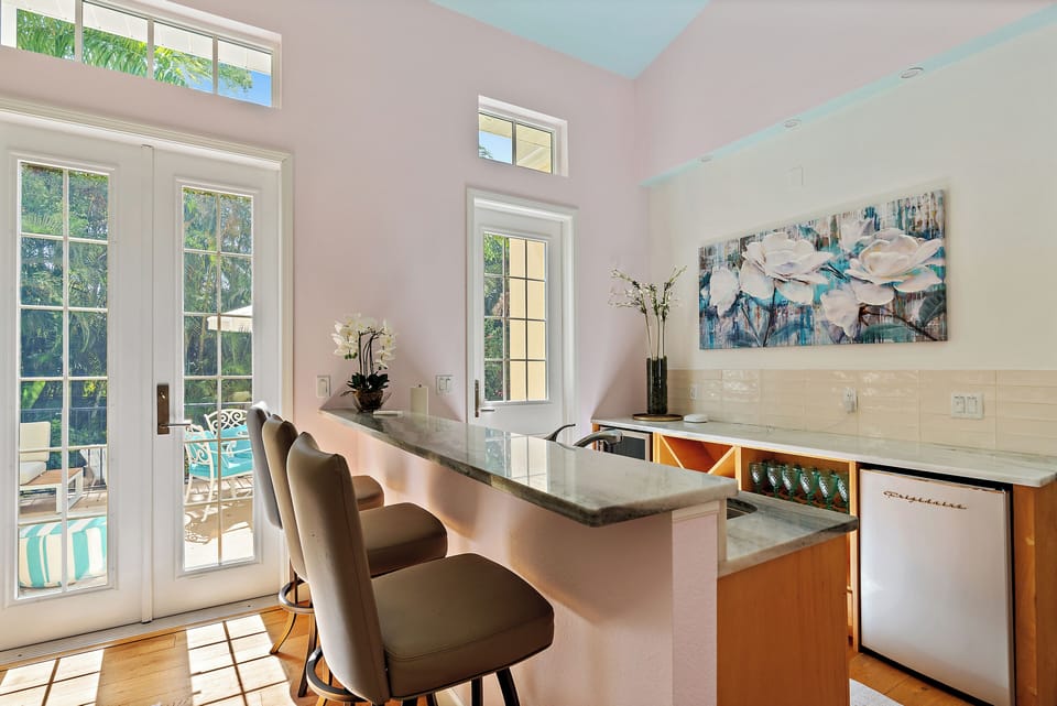 The downstairs bar features a mini fridge, sink, and bar items!