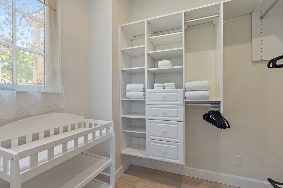 Walk in closet located through the full bath includes a changing table and pac n play.