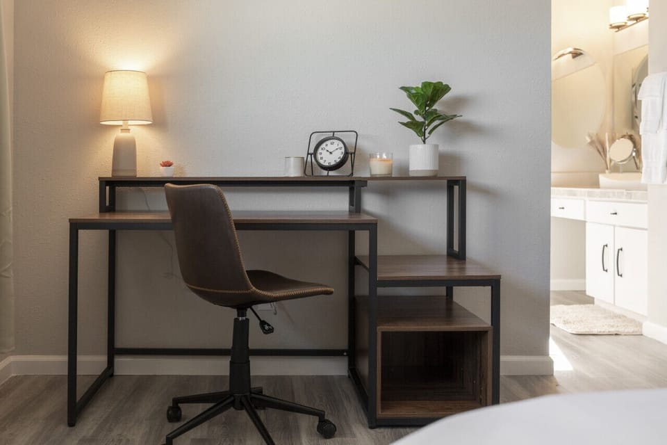 This bedroom offers a stylish desk, perfect for emails and creative work.