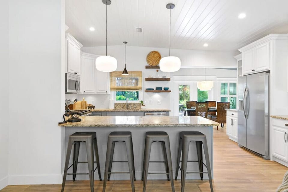 Bar stools between the living room and kitchen.