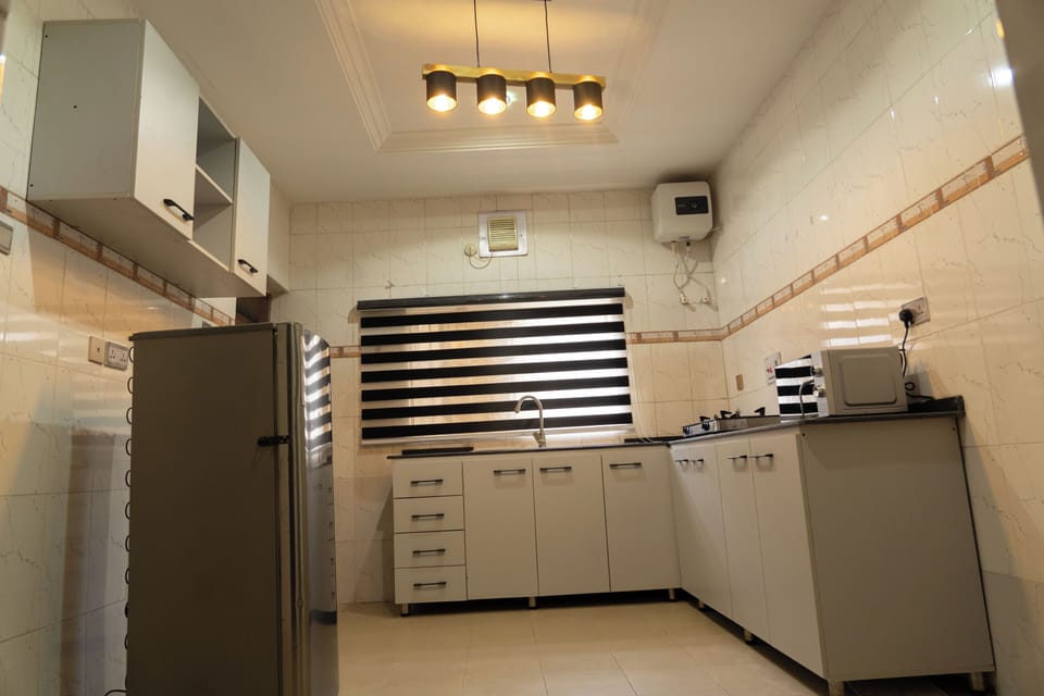 Luxury Apartment | Private kitchen | Full-size fridge, microwave, oven, toaster