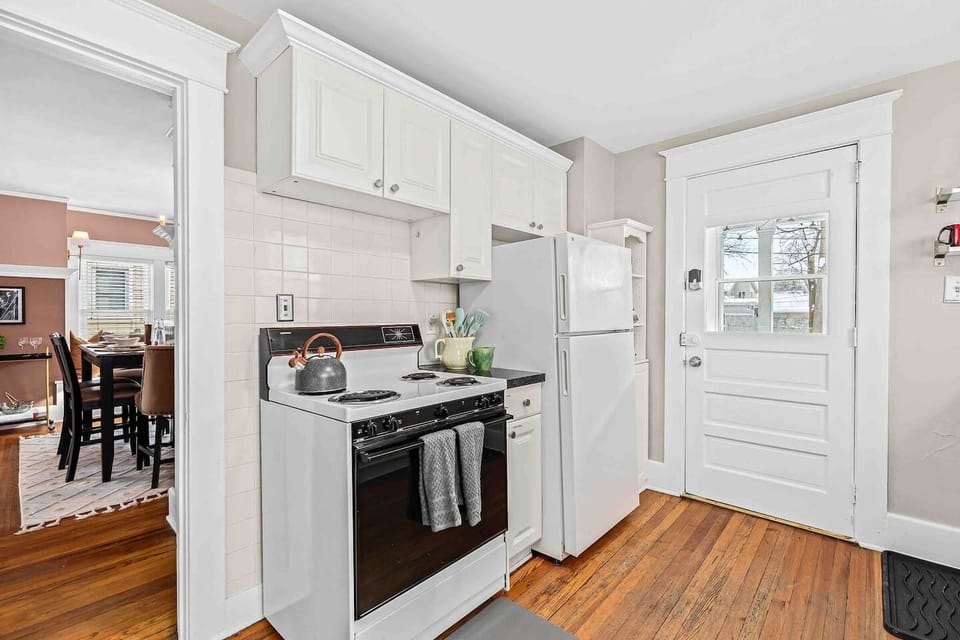 Kitchen includes fridge & stove as well as entry into the home