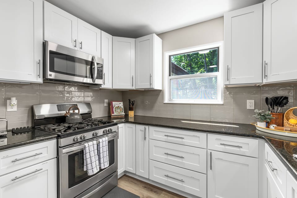 The kitchen with range oven and a microwave for your cooking needs.
